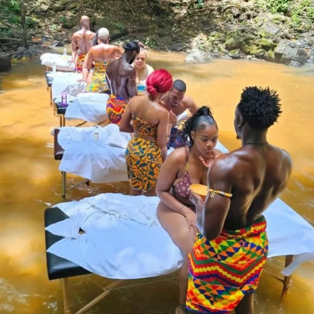 Massage tables in the river with traditional kente attire